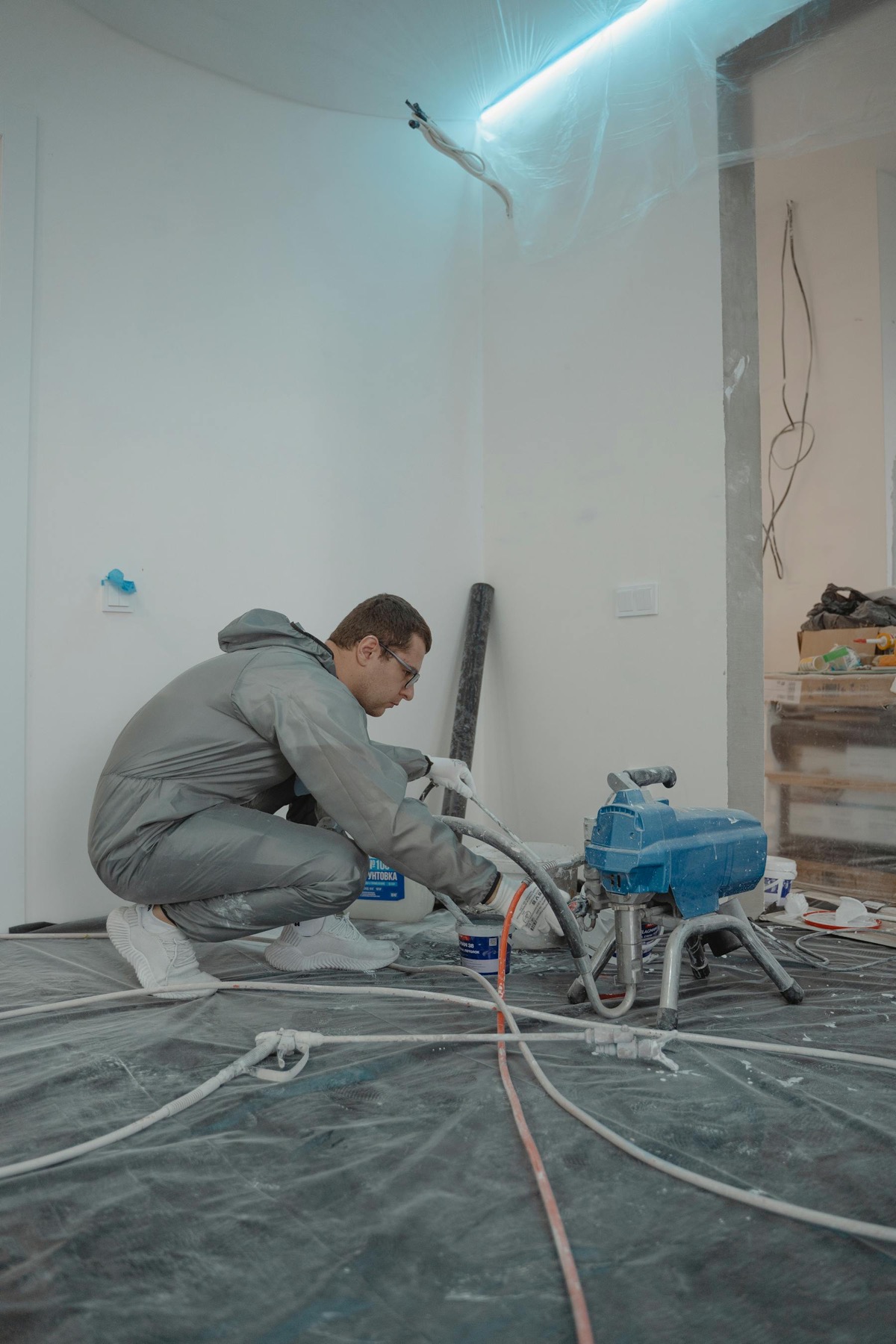 Restoration technician working with indoor drying and repair equipment